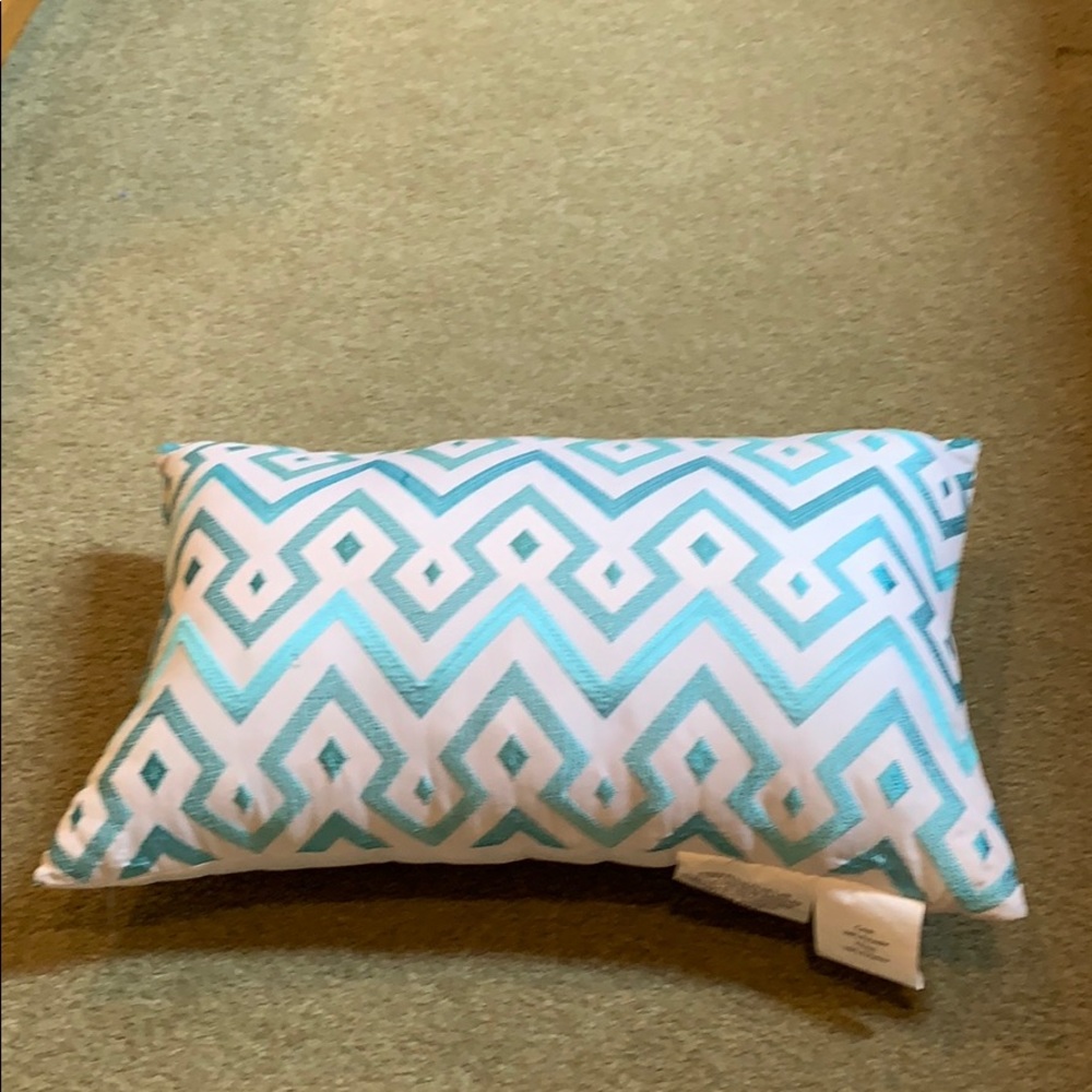 Rectangular accent pillow, white with teal blue chevron pattern.